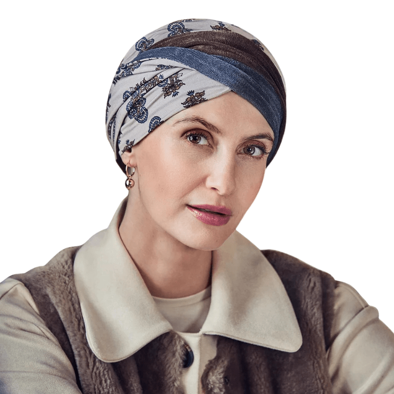 Woman wearing Shakti turban in beige, brown, dusty blue paisley print, headband twisted in front