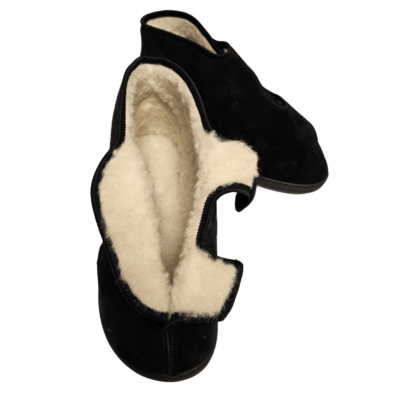 A black therapy shoe fully opened, clearly showing the thick, light wool lining