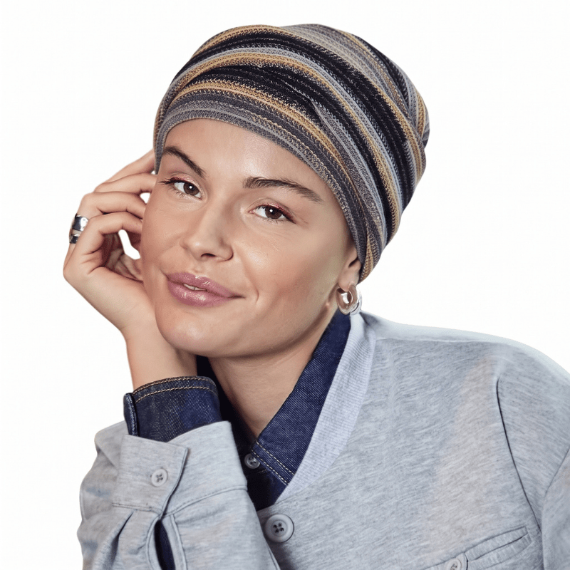 Smiling woman wearing Zoya turban in Black Autumn Stripes pattern with soft pleats, front view
