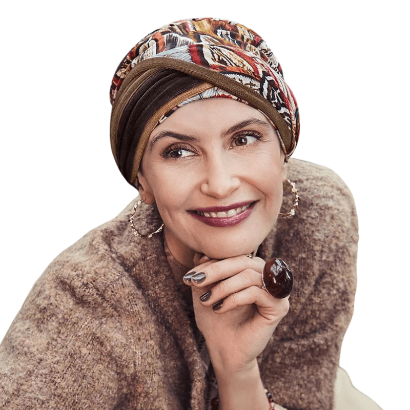 Smiling woman wearing Shakti turban with Tribal Feathers print in warm autumn colors
