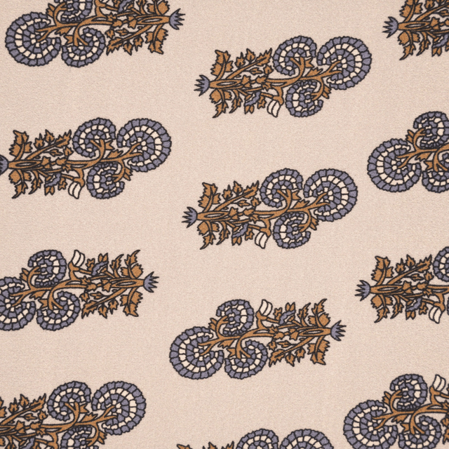 Close-up of the classic paisley pattern on the Beatrice turban in beige, brown, and dusty blue