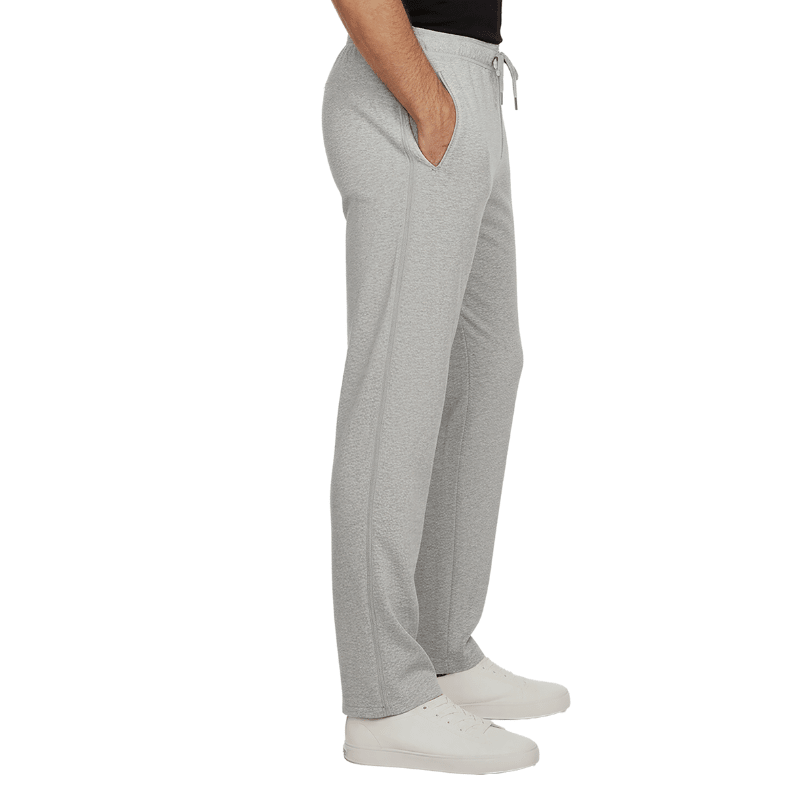 Grey jogging pants with closed side zippers and slash pockets, seen from the side on a person