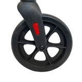 Close-up of a black puncture-proof rubber wheel on the Ibis rollator with a red reflector