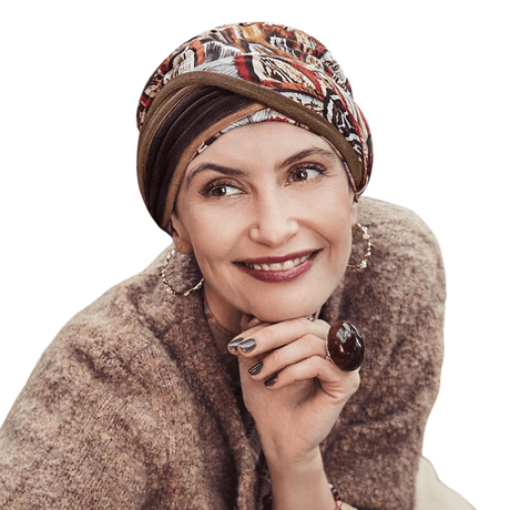 Smiling woman wearing Shakti turban with Tribal Feathers print in warm autumn colors