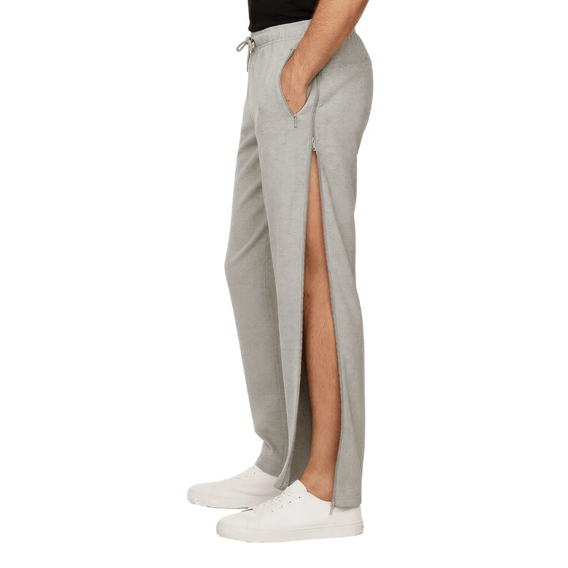 Grey jogging pants with open side zipper revealing the leg, seen from the side on a person