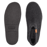 Two black Green Comfort wool felt slippers, one showing the non-slip rubber sole, the other the top